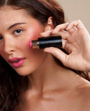 Model applying YB cream blush stick.