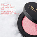 Pressed mineral blush pan showing sparkling rosy pink powder in black compact
