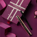 Mascara and eye liner holiday gift set with decorative box on a purple background