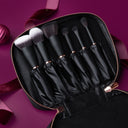 Set of makeup brushes in a black case on a purple background