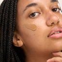 YB Model with foundation swatch on cheek