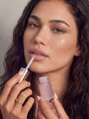 Model wearing YB EverGlow lip oil in Cosmo