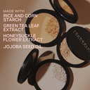 Pressed mineral rice powder in black compact pans, multiple shades
