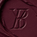 Close-up of a maroon color swatch with a YB logo in the center