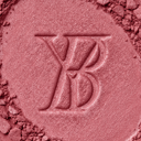 Close-up of pink makeup powder with a YB brand logo